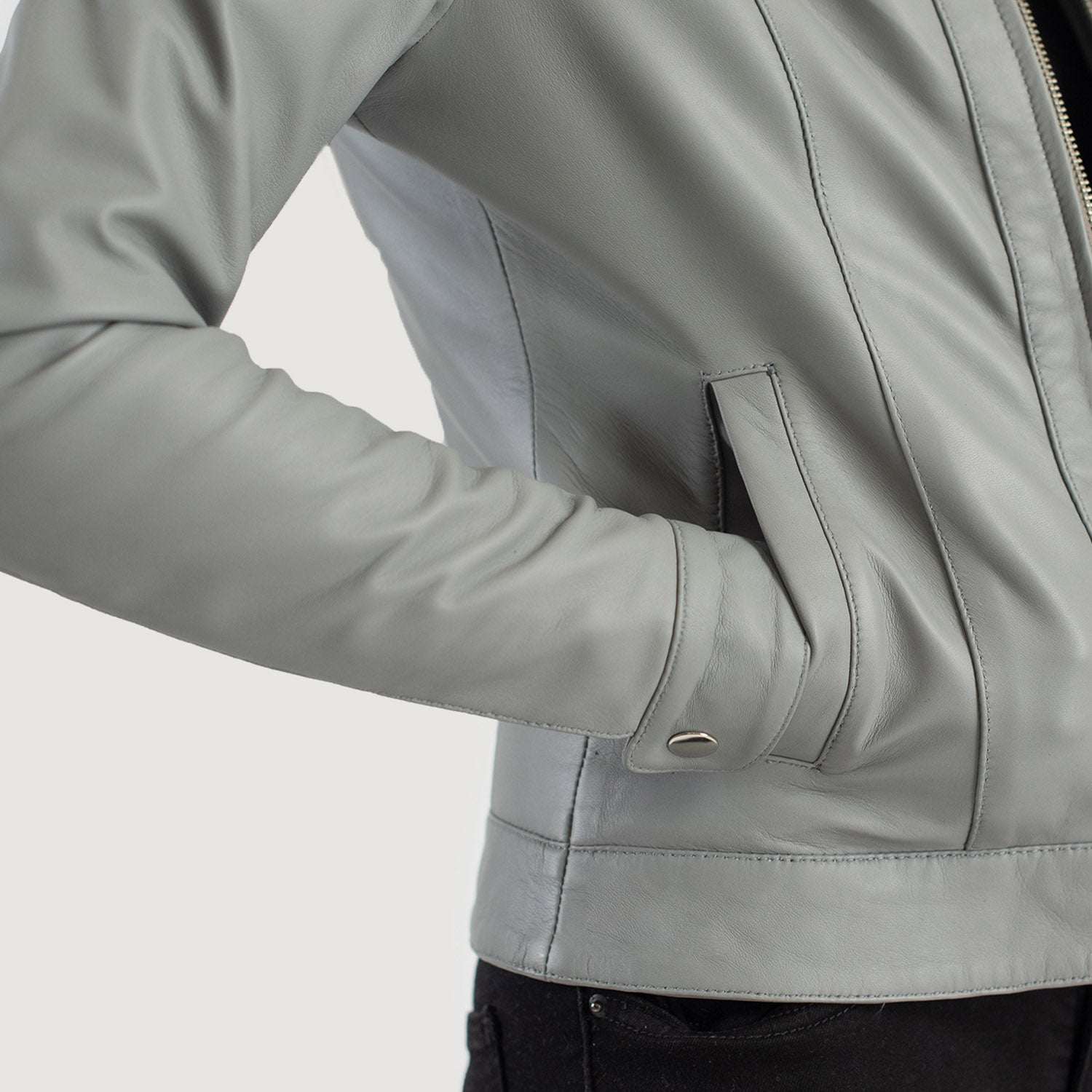 Close-up of a light gray leather jacket with a blurred background